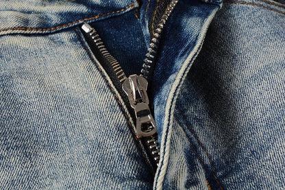 American High Street fashionable men's ripped black and white patch jeans in a light blue denim color