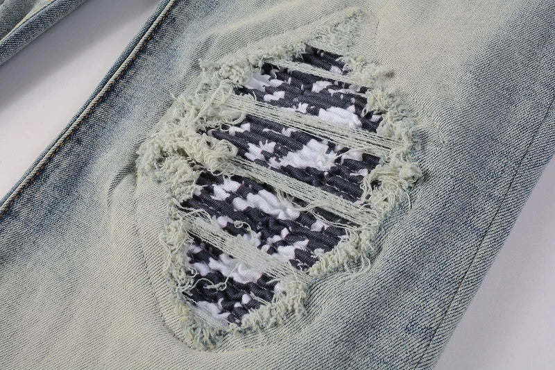 American High Street fashionable men's ripped black and white patch jeans in a light blue denim color