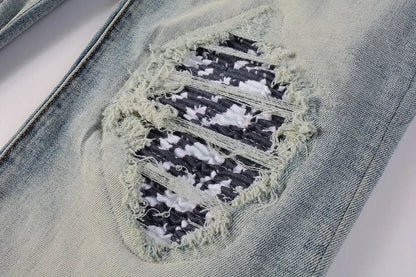 American High Street fashionable men's ripped black and white patch jeans in a light blue denim color