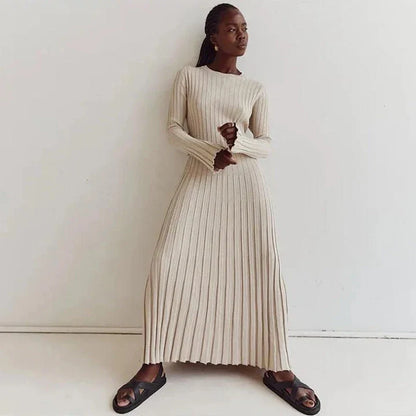Timeless elegant pleated knit dress in black, perfect for summer office wear with a sophisticated and comfortable design.