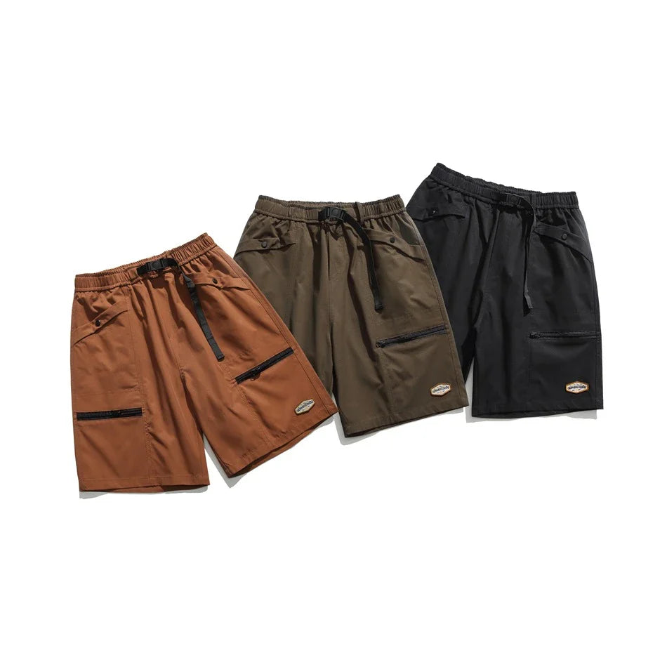 Mountain Vintage Workwear Shorts in black, orange, and army green colors, featuring a fifth-length design and convenient pockets for versatile functionality.