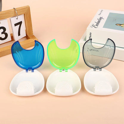 Compact, transparent dental retainer storage box with a push-to-open mechanism for easy access to dental appliances