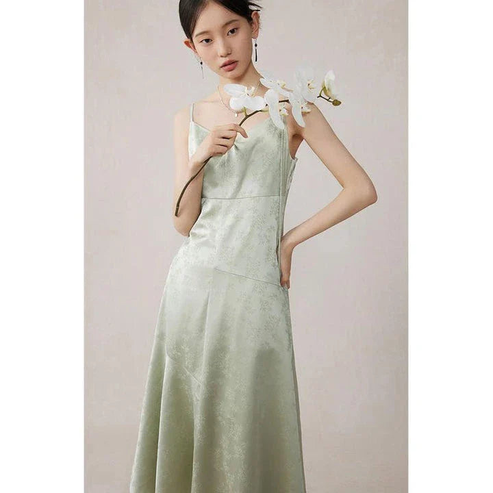 Elegant mint green midi dress with spaghetti straps, featuring a slim fit and intricate embroidery details