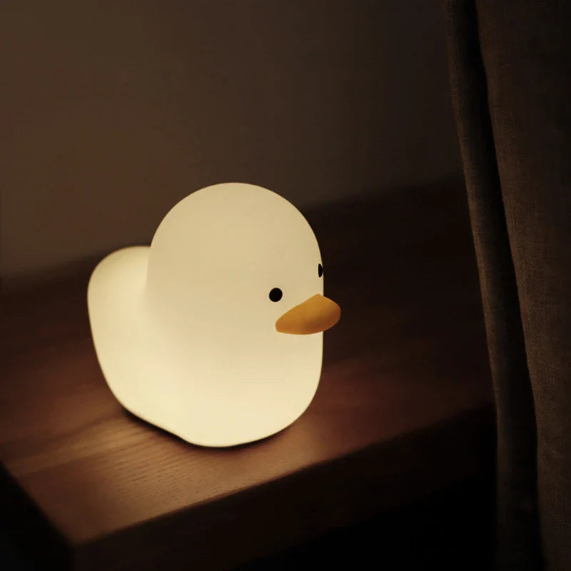 Cute duck-shaped LED night light with silicone and ABS construction, USB charging, and adjustable brightness