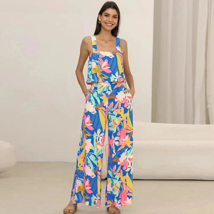 A stylish wide-leg jumpsuit with a paisley print design and a suspender top, perfect for women's casual and streetwear fashion.