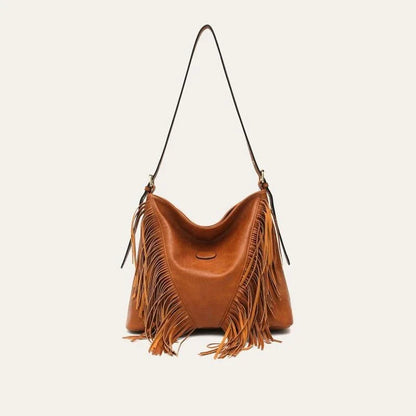 Chic vegan leather shoulder bag with tassel decoration, featuring a spacious interior and versatile carrying options
