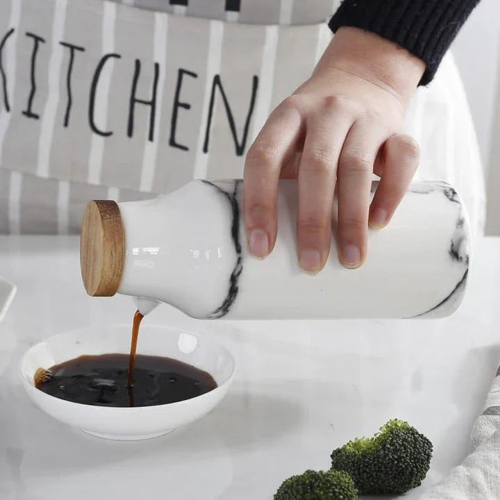 Elegant ceramic salt and pepper oil bottle set with wooden lids, perfect for storing and displaying seasonings and cooking oils in a modern kitchen