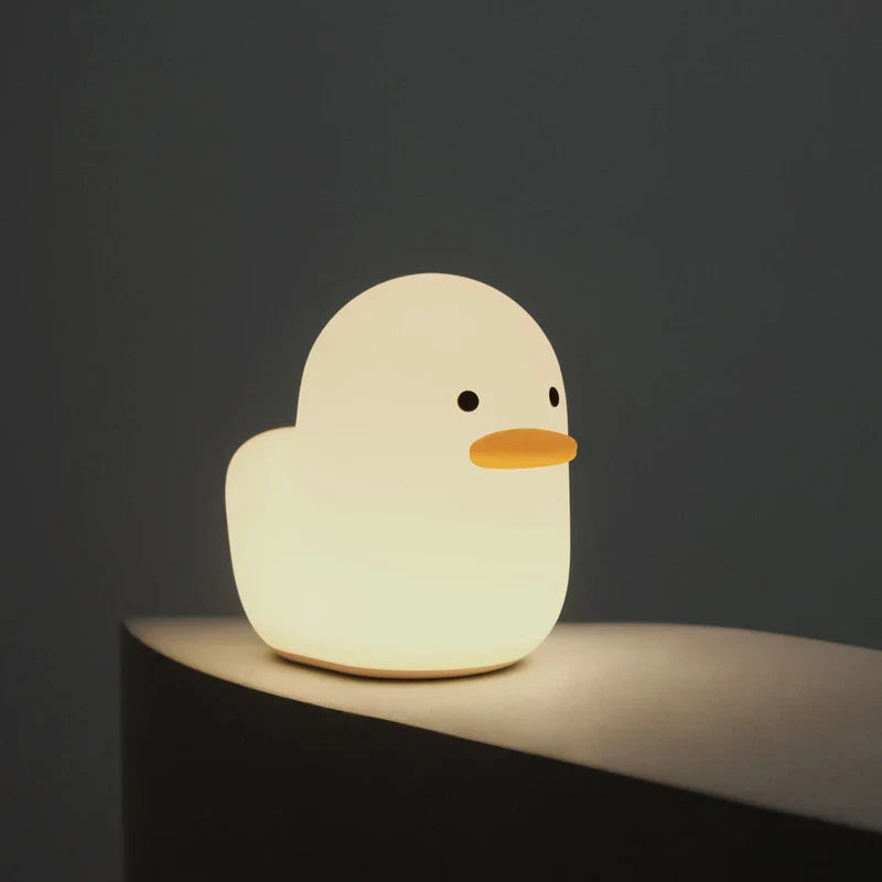 Cute duck-shaped LED night light with silicone and ABS construction, USB charging, and adjustable brightness
