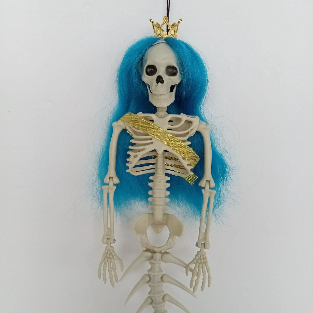 Mermaid bone pendant in various colors, including brown, dark purple, burgundy, and lake blue, hanging outdoors for Halloween decoration