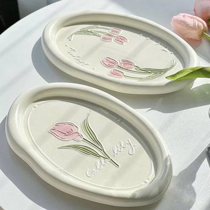 Elegant ceramic plate featuring a delicate floral relief design of Calla Lily and Tulip flowers, perfect for refined dining
