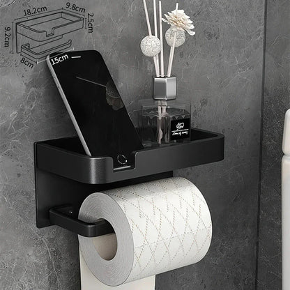 Black and gold aluminum bathroom paper holder with a convenient phone shelf, a stylish and functional accessory for modern bathrooms.