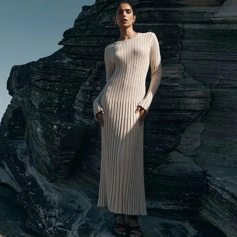 Timeless elegant pleated knit dress in black, perfect for summer office wear with a sophisticated and comfortable design.