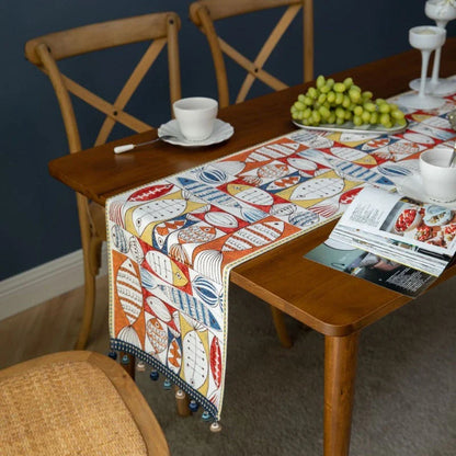 Festive jacquard table runner with vibrant fish design, available in multiple sizes to fit various dining tables
