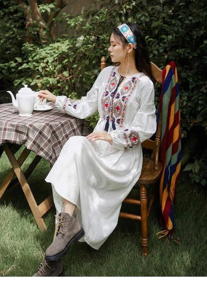 Elegant embroidered cotton-linen dress with tassels, featuring a waist-cinching A-line silhouette in vibrant colors