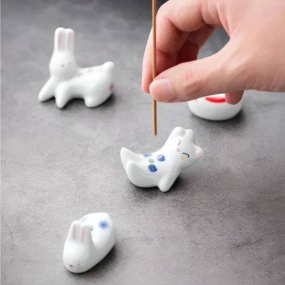 Charming ceramic incense holder featuring a cute rabbit and kitten design, perfect for adding a touch of whimsy and tranquility to any room.