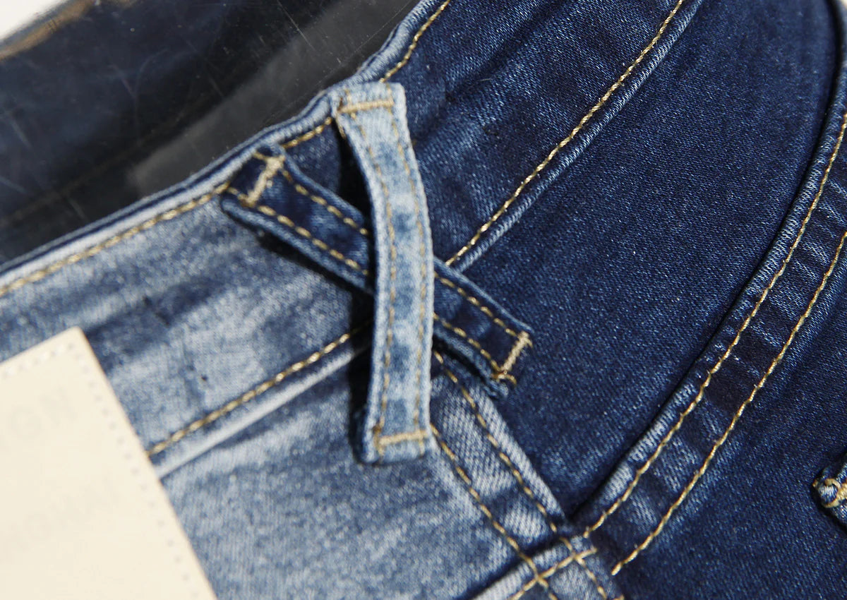 Geometric raw edge jeans with high-waisted, slimming design in blue denim