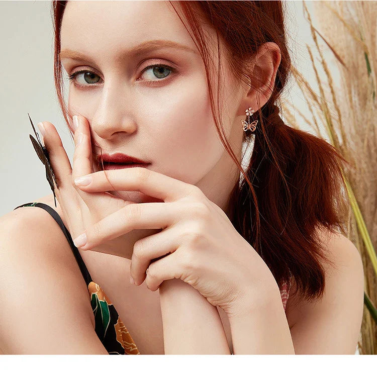 Elegant silver earrings featuring a delicate butterfly design with shimmering white crystals