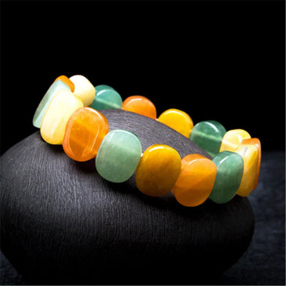 Closeup of a natural tiger eye crystal bracelet with a geometric design, showcasing its unique and calming beauty.
