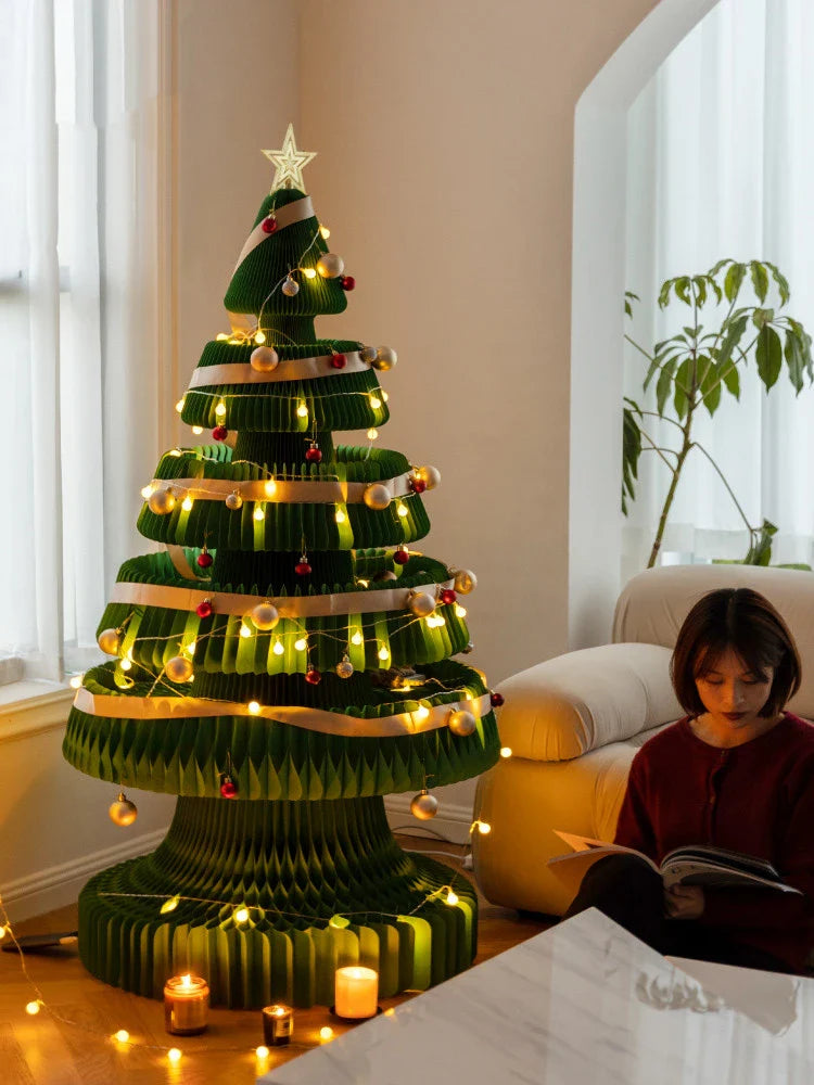 Intricate origami-style paper Christmas tree decoration in a modern, minimalist design