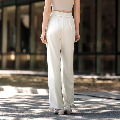 Effortless wide-leg summer trousers for women in white, featuring a relaxed fit, breathable cotton fabric, and functional pockets