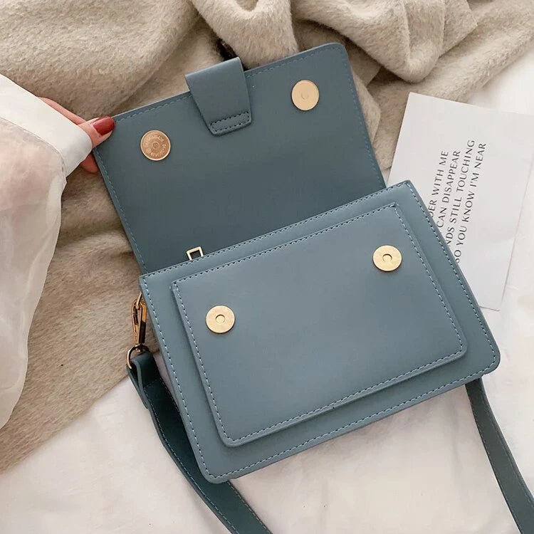 Stylish black crossbody shoulder bag with adjustable strap and multiple interior compartments for modern women