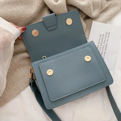 Stylish black crossbody shoulder bag with adjustable strap and multiple interior compartments for modern women