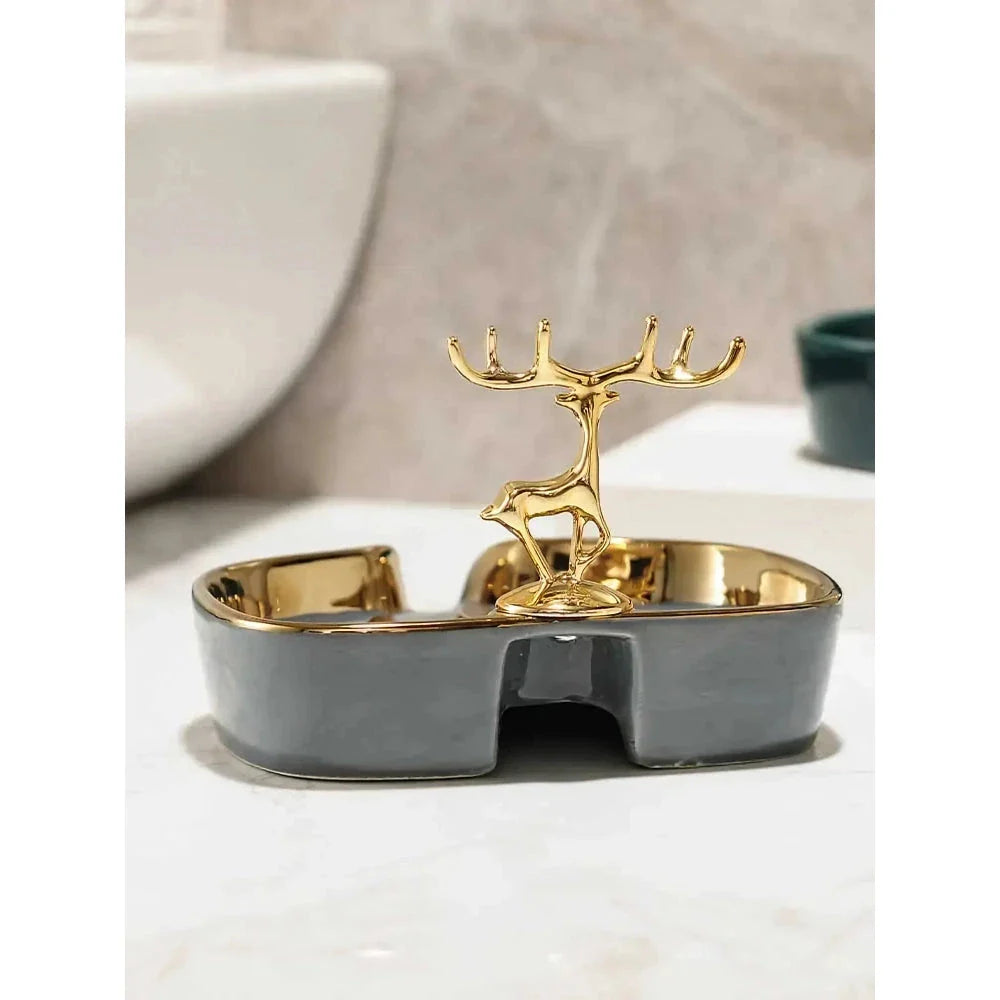 A white gold ceramic soap dish with a drainage design, showcasing a sleek and elegant bathroom accessory.