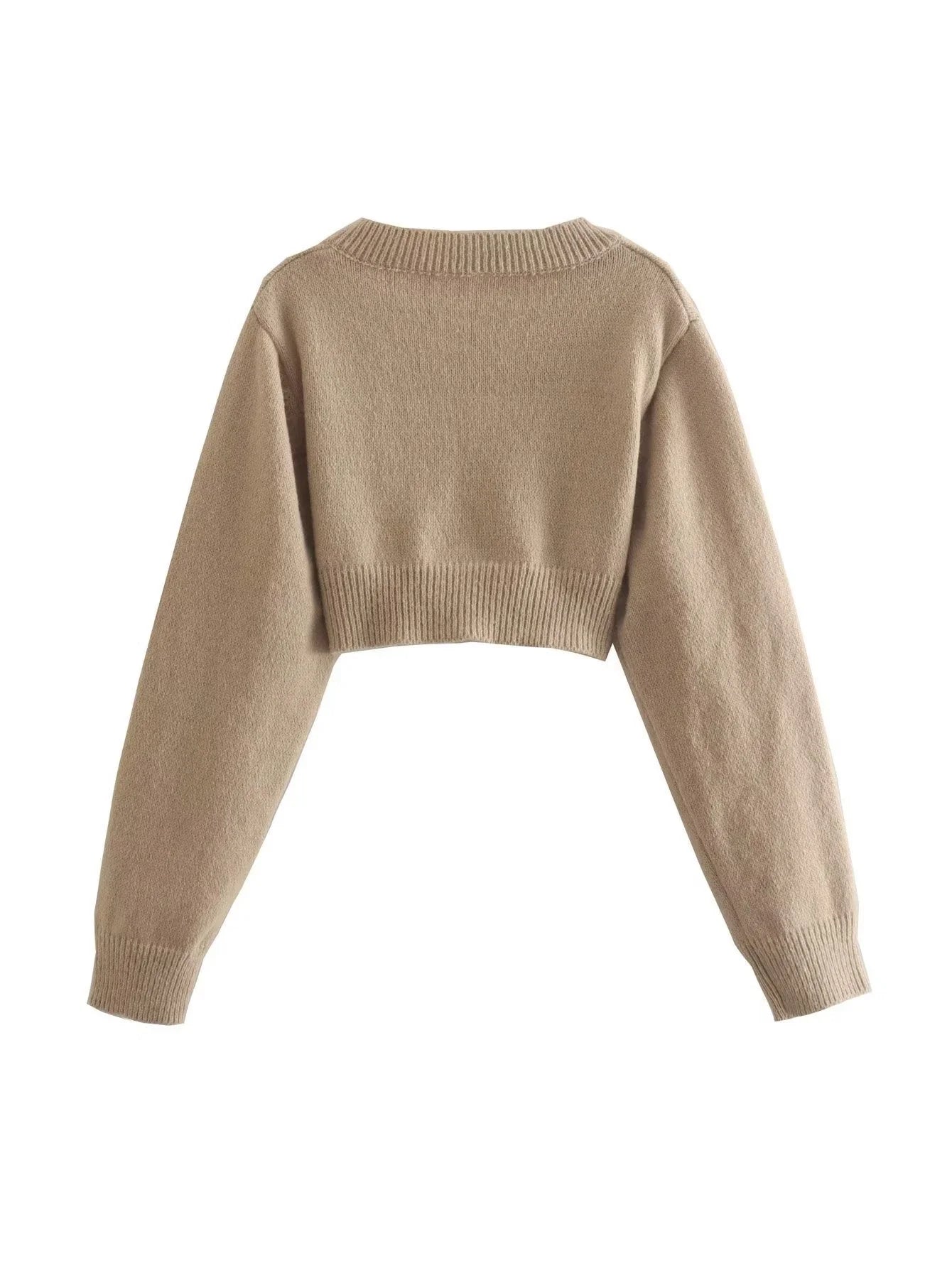 A cozy, knitted pullover sweater with a timeless round neck design, available in a versatile camel color.