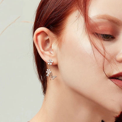 Elegant silver earrings featuring a delicate butterfly design with shimmering white crystals