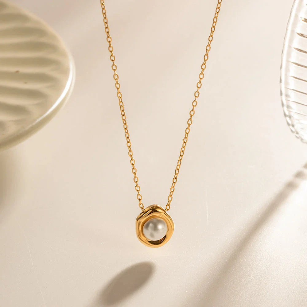 Elegant stainless steel pearl pendant necklace with a geometric design, perfect for women's fashion and everyday style.