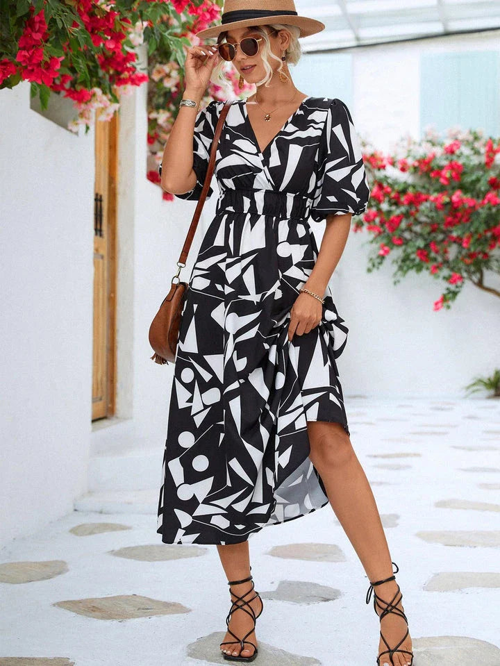 A stylish printed surplice dress with balloon sleeves, perfect for effortless elegance