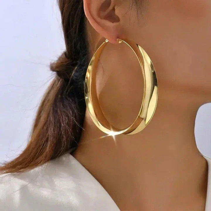 Glossy geometric metal hoop earrings in a silver finish, a trendy and versatile fashion accessory