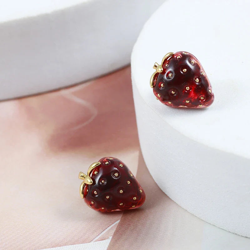 Fashionable red resin stereo strawberry stud earrings for women, featuring a captivating 3D illusion design