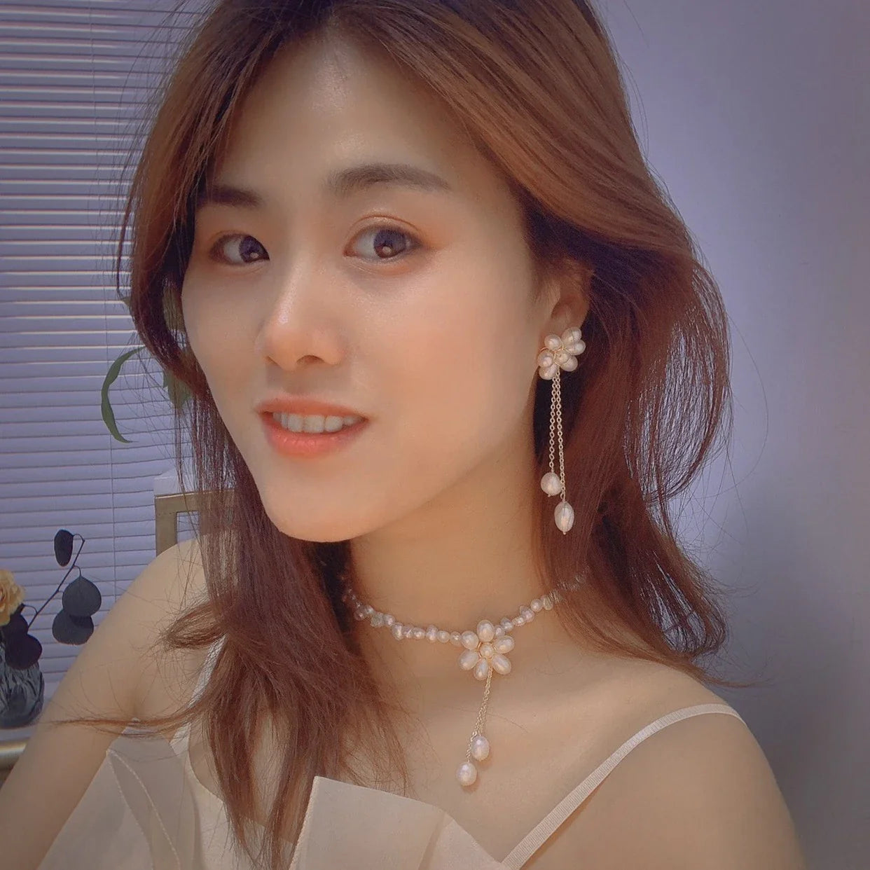 Elegant 14K gold-plated necklace with natural freshwater pearls in a unique cross-chain design