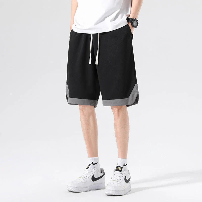 Men's loose and comfortable sports pirate shorts in white, gray, and black colors with elasticized waistband and relaxed fit
