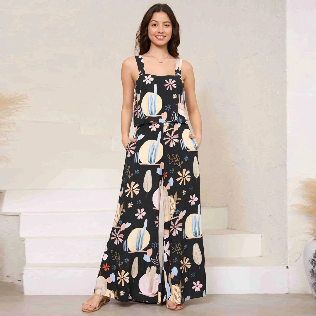 A stylish wide-leg jumpsuit with a paisley print design and a suspender top, perfect for women's casual and streetwear fashion.