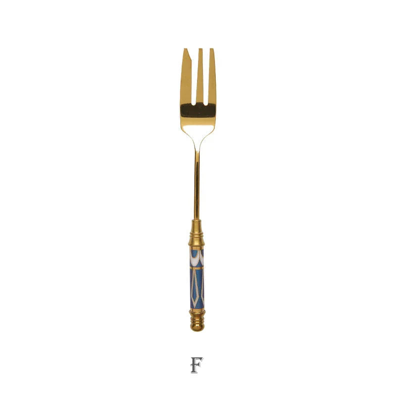 Elegant gold-plated dessert fork with intricate ceramic handle design