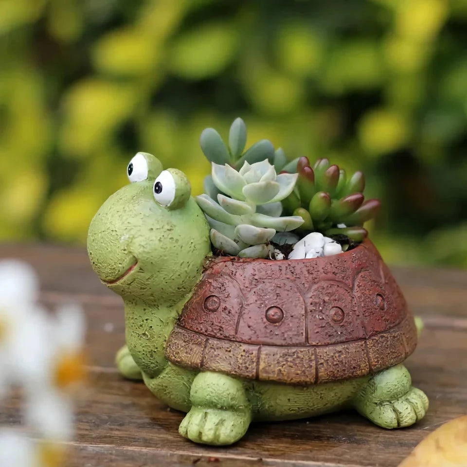 Charming gray cartoon turtle planter holding small potted succulents and cacti