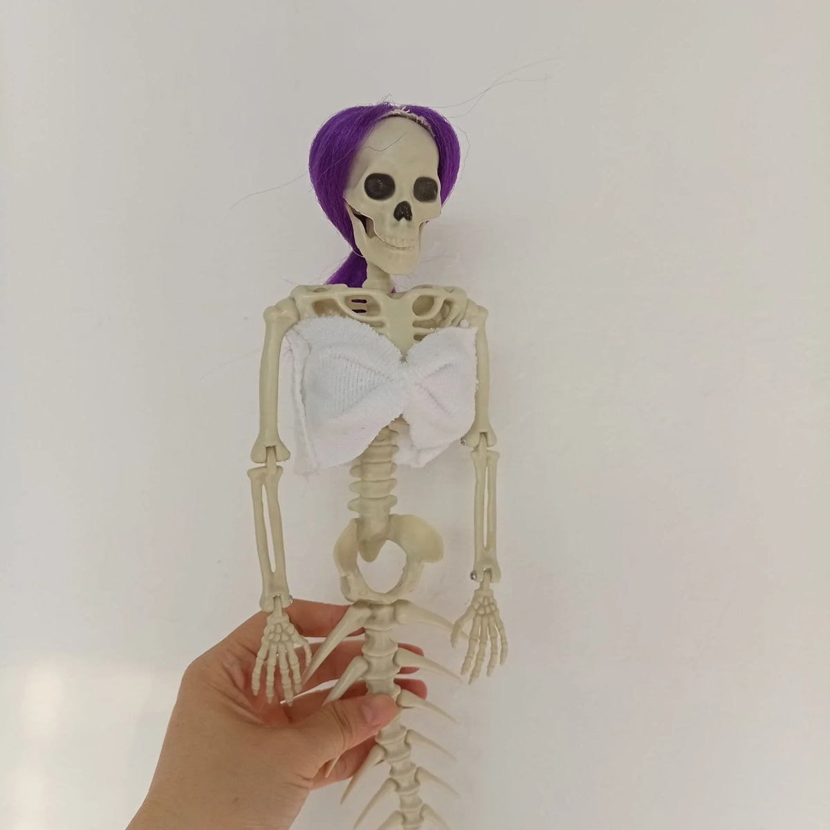 Mermaid bone pendant in various colors, including brown, dark purple, burgundy, and lake blue, hanging outdoors for Halloween decoration