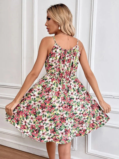 A stylish floral print suspender dress with an elastic waist, perfect for summer fashion and casual or dressy occasions.