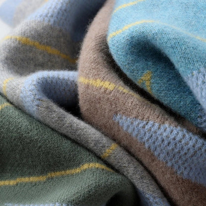 A cozy, plaid pullover sweater in gray, lake blue, purple velvet camel, and olive green colors, featuring a relaxed fit and premium wool construction for warmth and comfort.