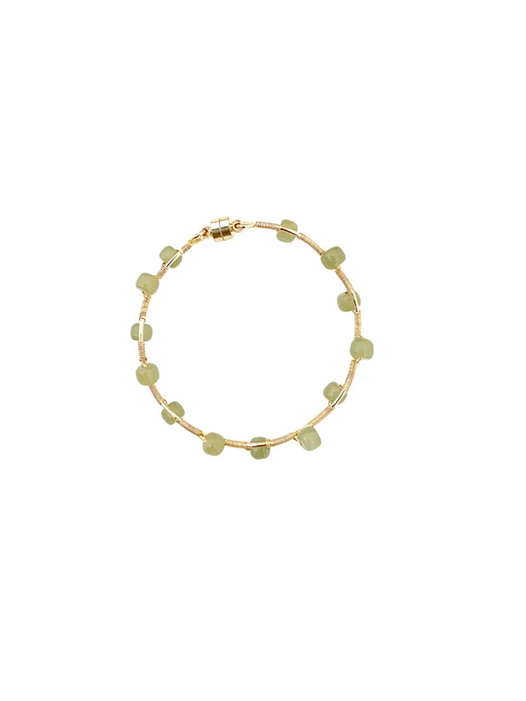 Elegant handcrafted Hetian jade bracelet with a captivating wave pattern, a sophisticated accessory that adds natural beauty to any outfit.
