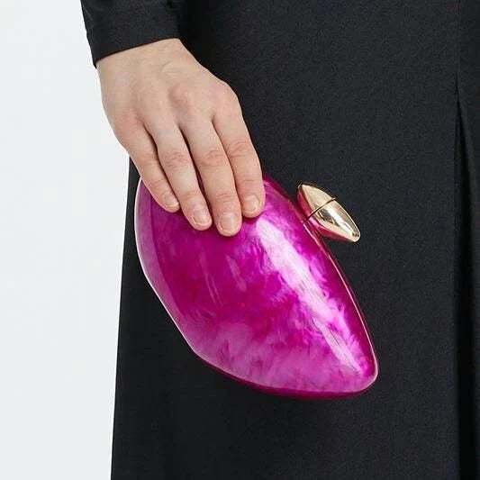 Elegant acrylic rose-colored clutch with delicate diamond-like decorations, perfect for formal events and special occasions.