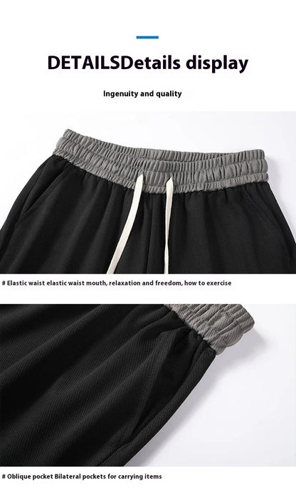 Men's loose and comfortable sports pirate shorts in white, gray, and black colors with elasticized waistband and relaxed fit