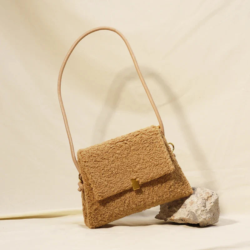 Stylish faux lamb wool crossbody shoulder bag in neutral colors with a cozy, plush exterior and organized interior pockets