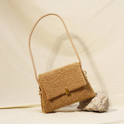 Stylish faux lamb wool crossbody shoulder bag in neutral colors with a cozy, plush exterior and organized interior pockets