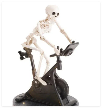 Animated skeleton cycling ornament in white, with the skeleton gracefully pedaling a tiny bicycle