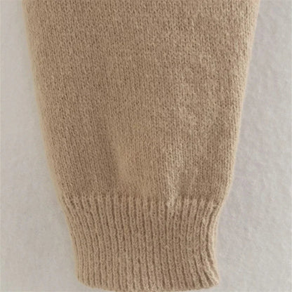 A cozy, knitted pullover sweater with a timeless round neck design, available in a versatile camel color.