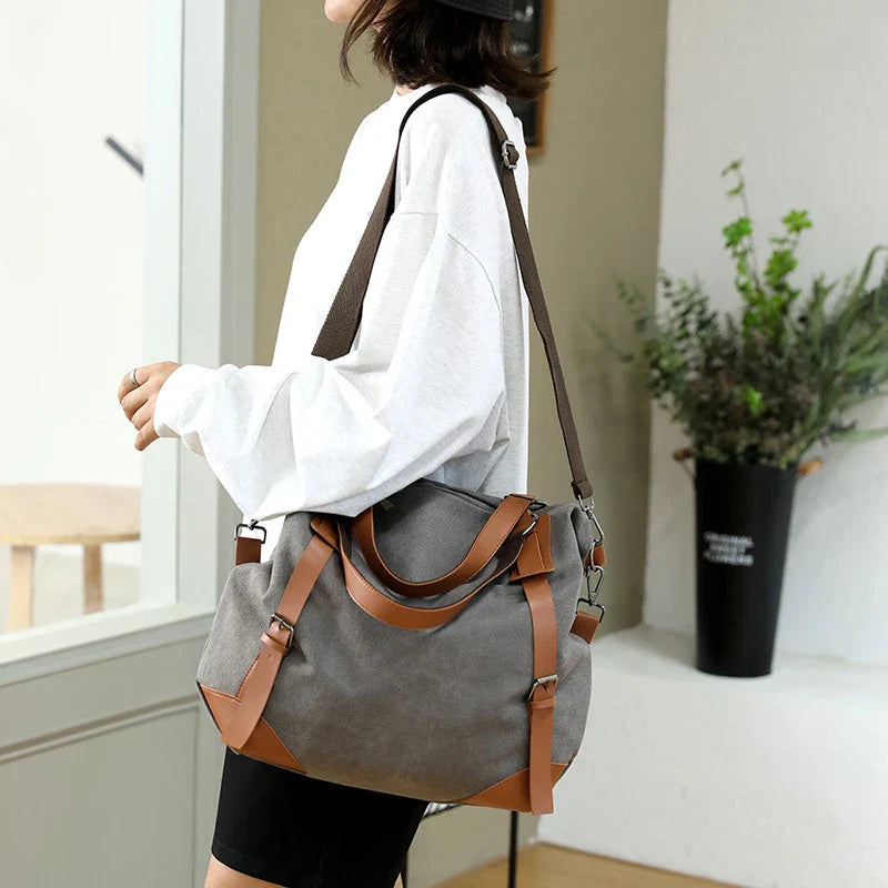 Versatile canvas shoulder bag in khaki color with multiple pockets and adjustable strap for everyday use