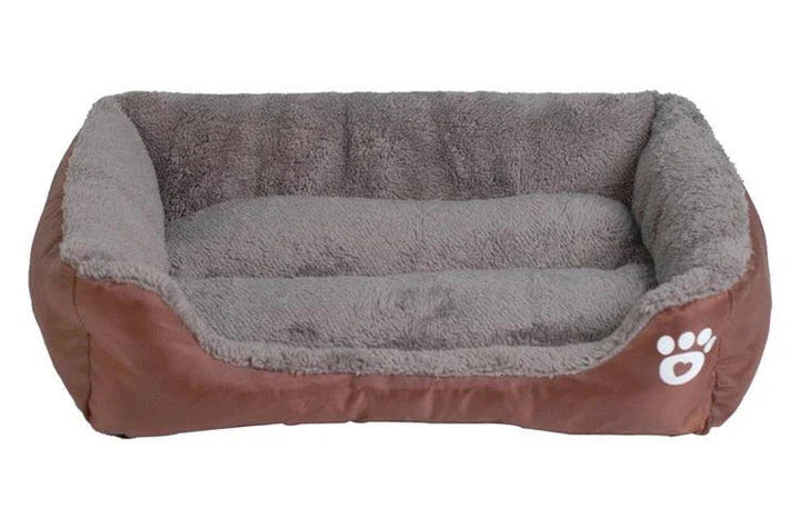 A plush, green pet bed with a paw-print pattern, designed to provide cozy and waterproof comfort for pets.